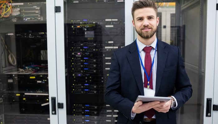 Portrait of technician using digital tablet in server room